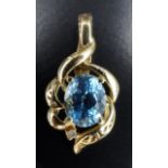 A late 20th Century topaz and diamond pendant, the 10 x 8 mm oval topaz surrounded by asymmetric
