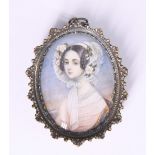 A mid 19th Century portrait miniature of a young lady in period costume and wearing a multi-strand