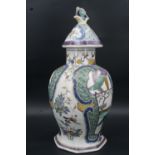 A Chinese Famille Verte porcelain covered jar or vase, of ovoid form with faceted conical cover