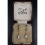 A pair of late 19th /early 20th Century baroque pearl and 9 ct yellow metal ear pendants, the pearls