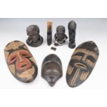 Late 20th Century African carved masks, a carved ebony head, terracotta busts, etc
