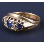 A Victorian sapphire and diamond dress ring, having a 4 mm sapphire flanked by 3 mm sapphires,