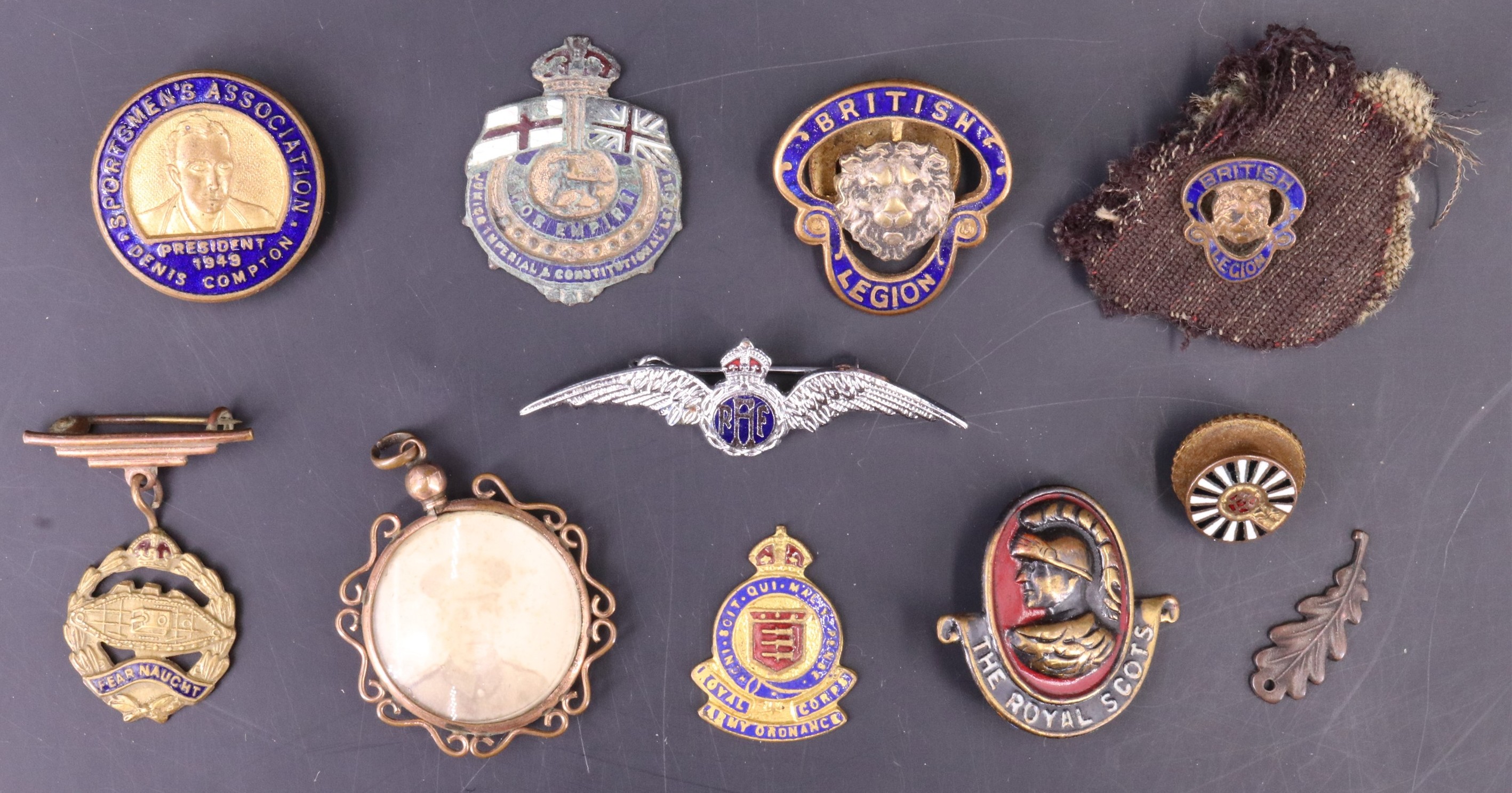 A small group of sweetheart brooches, lapel badges and a military pendant locket