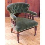 An Edwardian upholstered walnut tub chair, having a turned gallery back, 80 cm high