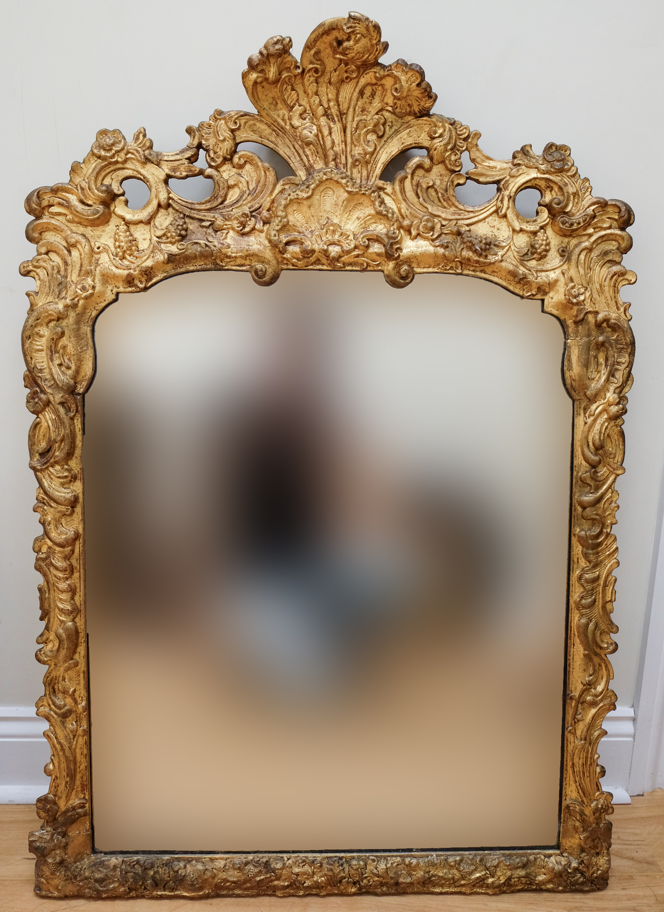 A Victorian Rococo influenced gilt frame mirror, having shells and scrolls augmented by fruiting
