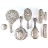 Four early 20th Century silver-backed brushes together with two hand mirrors and two silver lidded