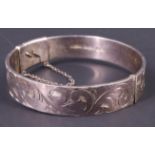 An engraved silver bangle, having an offset catch, Birmingham, 1972, 35.46 g, 12 mm wide, 54 x 56 mm