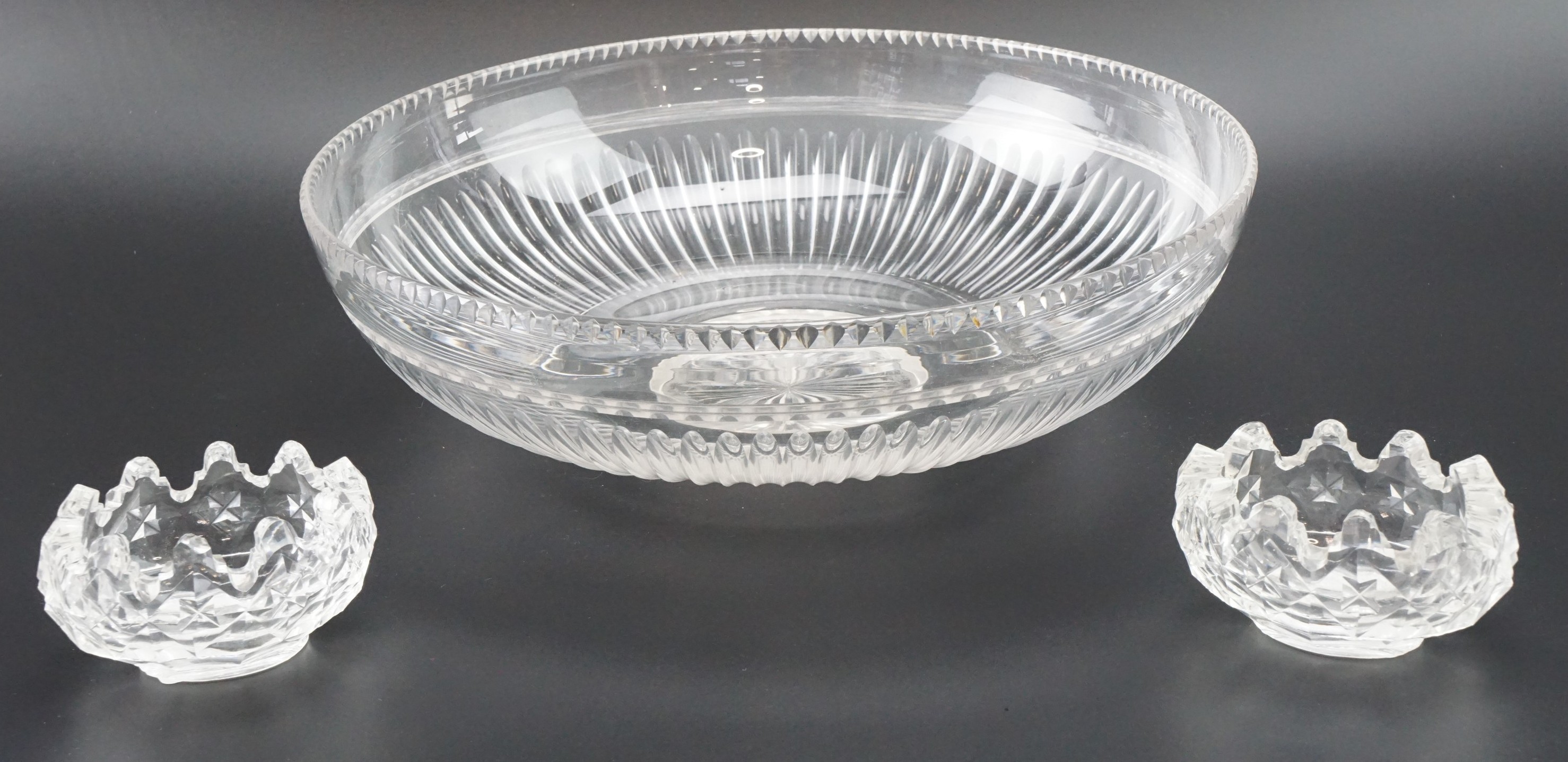 A cut glass centre bowl, having fluted decoration, together with a pair of heavy cut glass salt