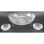 A cut glass centre bowl, having fluted decoration, together with a pair of heavy cut glass salt