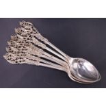 A set of six Edwardian silver teaspoons, having floral decorated cast and pierced terminals, London,