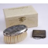 A cased child's vintage electroplate mounted hair brush and comb set, the brush back decorated in