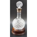 A contemporary silver collared cut glass port decanter on a turned wooden base, Birmingham, 2005, 33