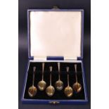 A cased set of enamelled and parcel gilt silver demitasse coffee spoons, the outside of each bowl