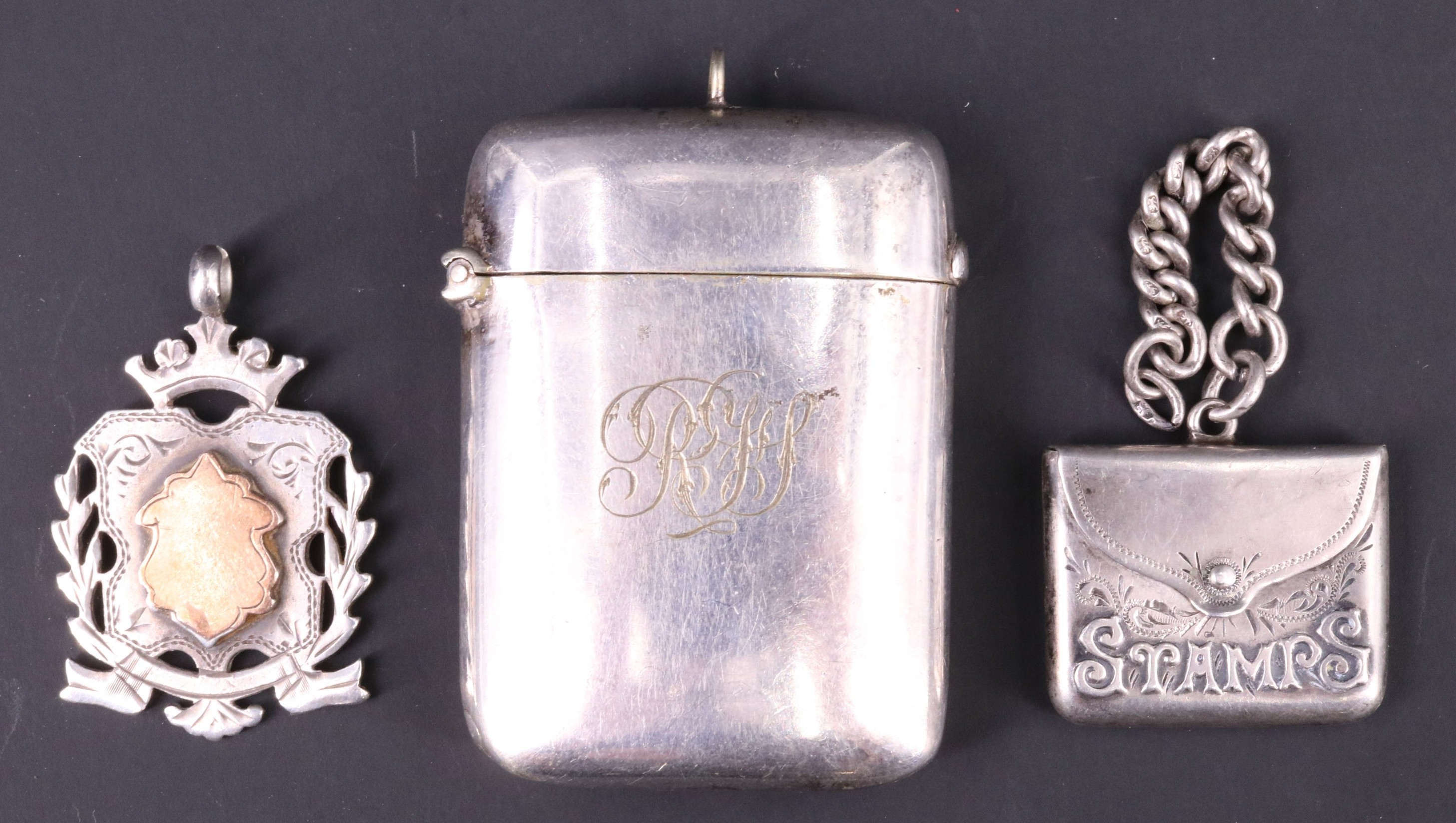 An Edwardian silver fob stamp case, of envelope form and having 'Stamps' embossed to the front,
