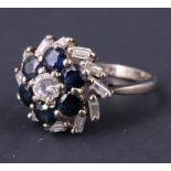 A vintage diamond and sapphire dress ring, the central brilliant .25 carat diamond set above six