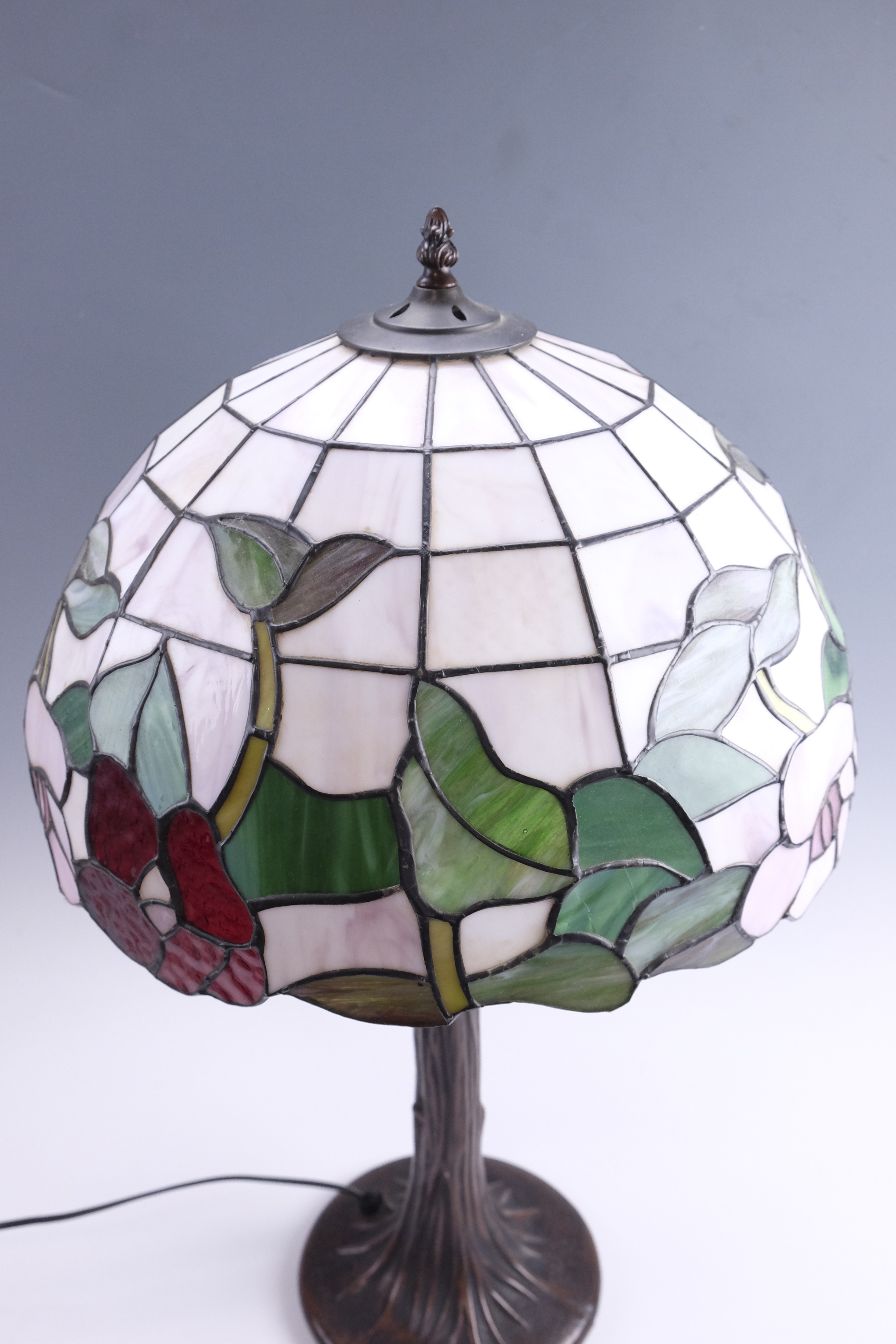 A late 20th Century Tiffany style table lamp, having a leaded glass shade on a patinated - Image 2 of 3