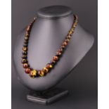 A Victorian matinee length tortoiseshell necklace, the beads addorse graduated from 20 mm to 7 mm