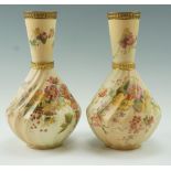 A pair of Edwarian Royal Worcester floral decorated blush ivory vases, of baluster form with an