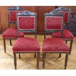 A set of four Edwardian oak dining chairs, the crest rails having carved fleur-de-lys, 99 cm high