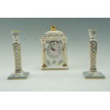 A Past Times mantle clock together with a pair of conforming candlesticks, clock 20 cm