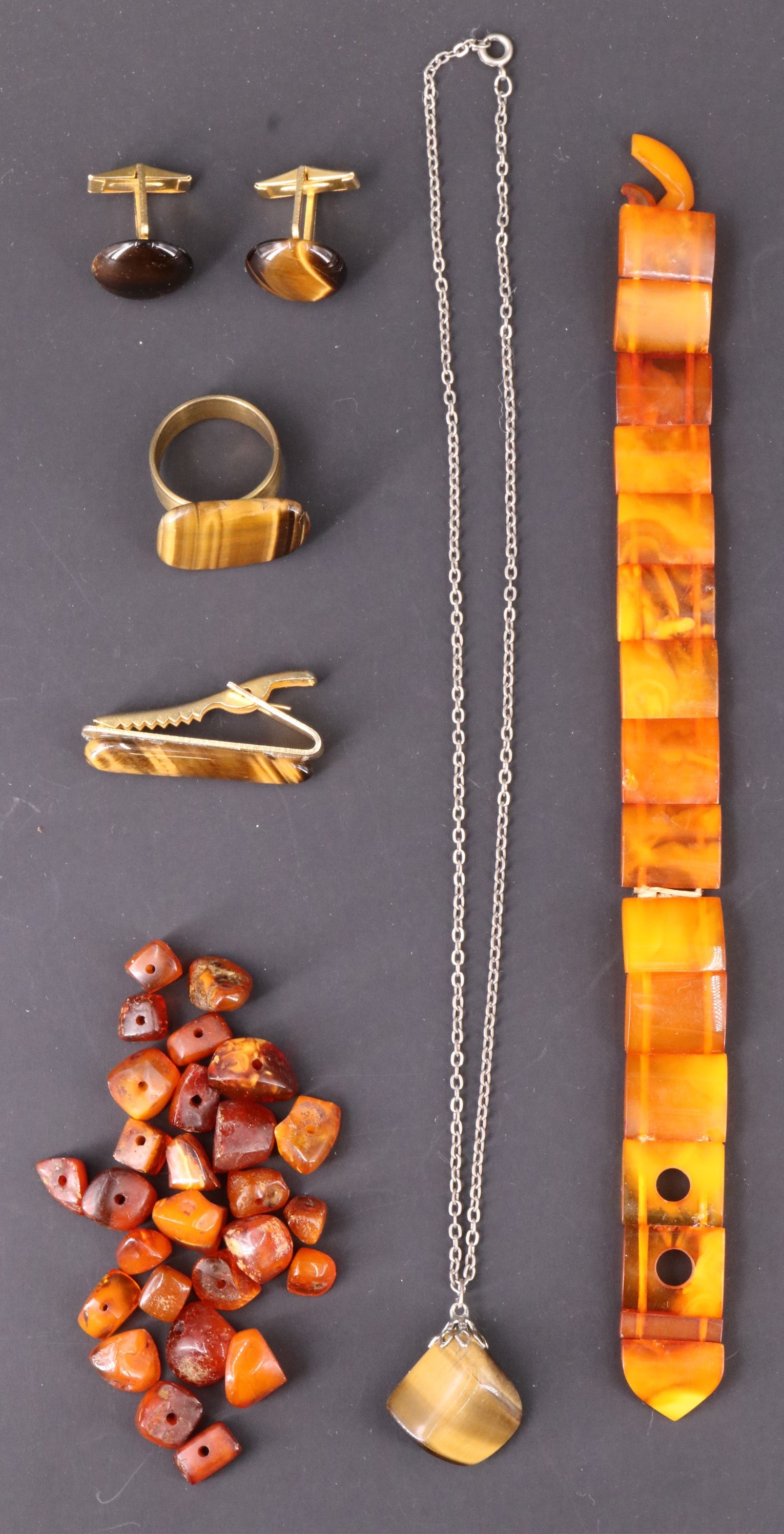 Four items of late 20th Century tiger's eye and gilt metal jewellery, including cufflinks and