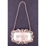 A silver 'Brandy' decanter label having embossed decoration, London, 1973, 14 g, 4 x 6 cm