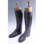 A pair of vintage leather riding boots and wooden trees
