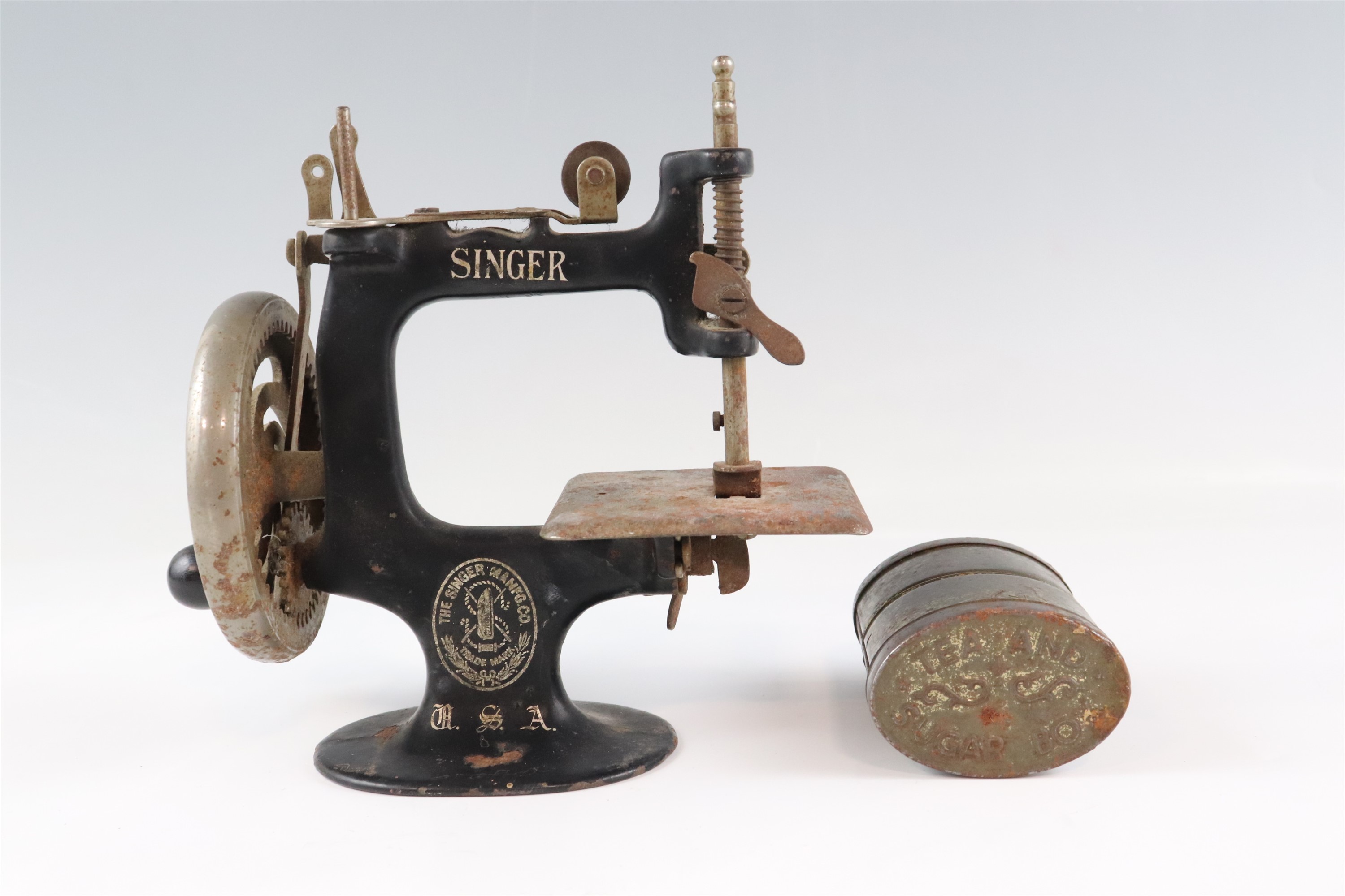 An early 20th Century toy hand-cranked Singer sewing machine together with an embossed double - Image 2 of 2