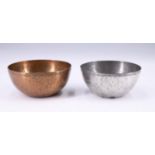 Two early 20th Century Arts and Crafts planished bowls, copper and pewter respectively, both