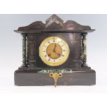 A late 19th / early 20th Century black slate and verde marble mantle clock, having a French drum