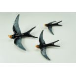 A set of three Beswick wall hanging swallows, 3156, 3157 and 3158, largest wingspan 22 cm, (a/f)