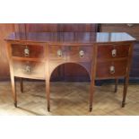 An old reproduction George III mahogany bow fronted sideboard, having a central cutlery drawer