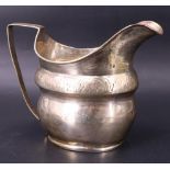 A George III silver milk jug of waisted helmet form and having bright cut decoration, possibly