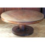 A large circular mahogany coffee table, 102 x 43 cm