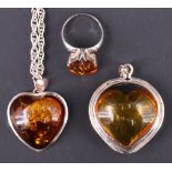 A contemporary sun spangled amber pendant necklace, being a 25 x 25 mm heart shaped amber cabochon