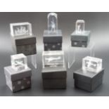 A group of boxed laser art glass paperweights