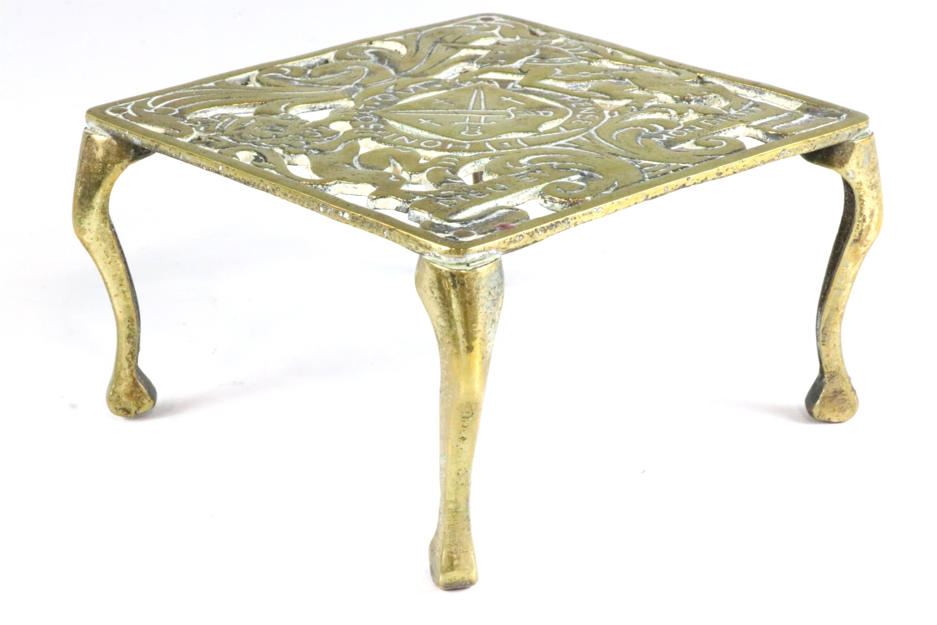 A Victorian cast brass trivet, having armorial decoration, a pair of ornate part candle holder - Image 6 of 6