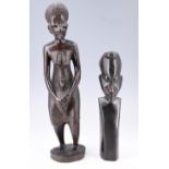 A mid-to-late 20th Century African carved hardwood figure of a woman with her baby, and a bust of