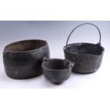 Three cast iron cooking pans, (two a/f), largest 30 x 43 x 21 cm