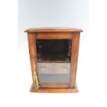 A George V oak smoker's cabinet, including a Millville pipe, 30 x 20 x 36 cm