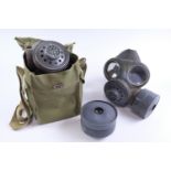 A British army lightweight respirator and haversack, one other respirator and a spare filter