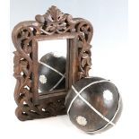 A late 20th Century carved and pierced Eastern hardwood framed mirror, together with a decorative