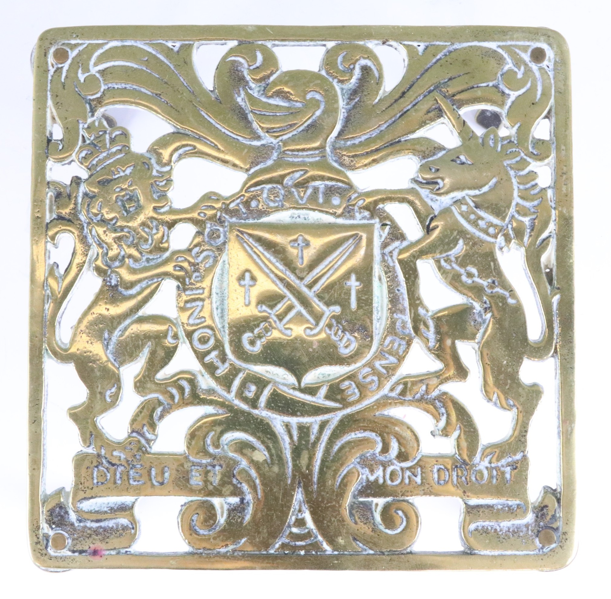 A Victorian cast brass trivet, having armorial decoration, a pair of ornate part candle holder - Image 5 of 6