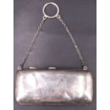 A George V silver finger purse, having a plain exterior, the front bearing an engraved monogram,