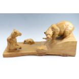 A large carved elm study of three bears in a river fishing, one standing atop a rapid, a salmon in