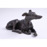 A late 20th Century patinated cast brass sculpture of a recumbent greyhound, 16 cm long