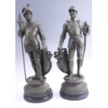 A pair of late 19th / early 20th Century spelter figurines of knights in armour, green patanated