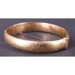 A 1960s 9 ct gold bangle, decorated with engraved scrolls, wax filled, Birmingham, 1966, 15.26 g, 52