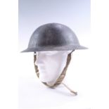 A Great War British army Brodie helmet shell with Second World War commercial liner and chin strap