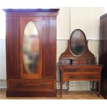 An Edwardian mahogany two piece bedroom suite, comprising a dressing chest and mirror door wardrobe,